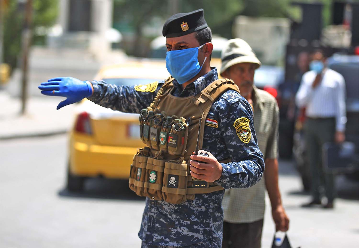 Member of the Iraqi security forces wearing protective masks keep watch at Tahrir Square in central Baghdad