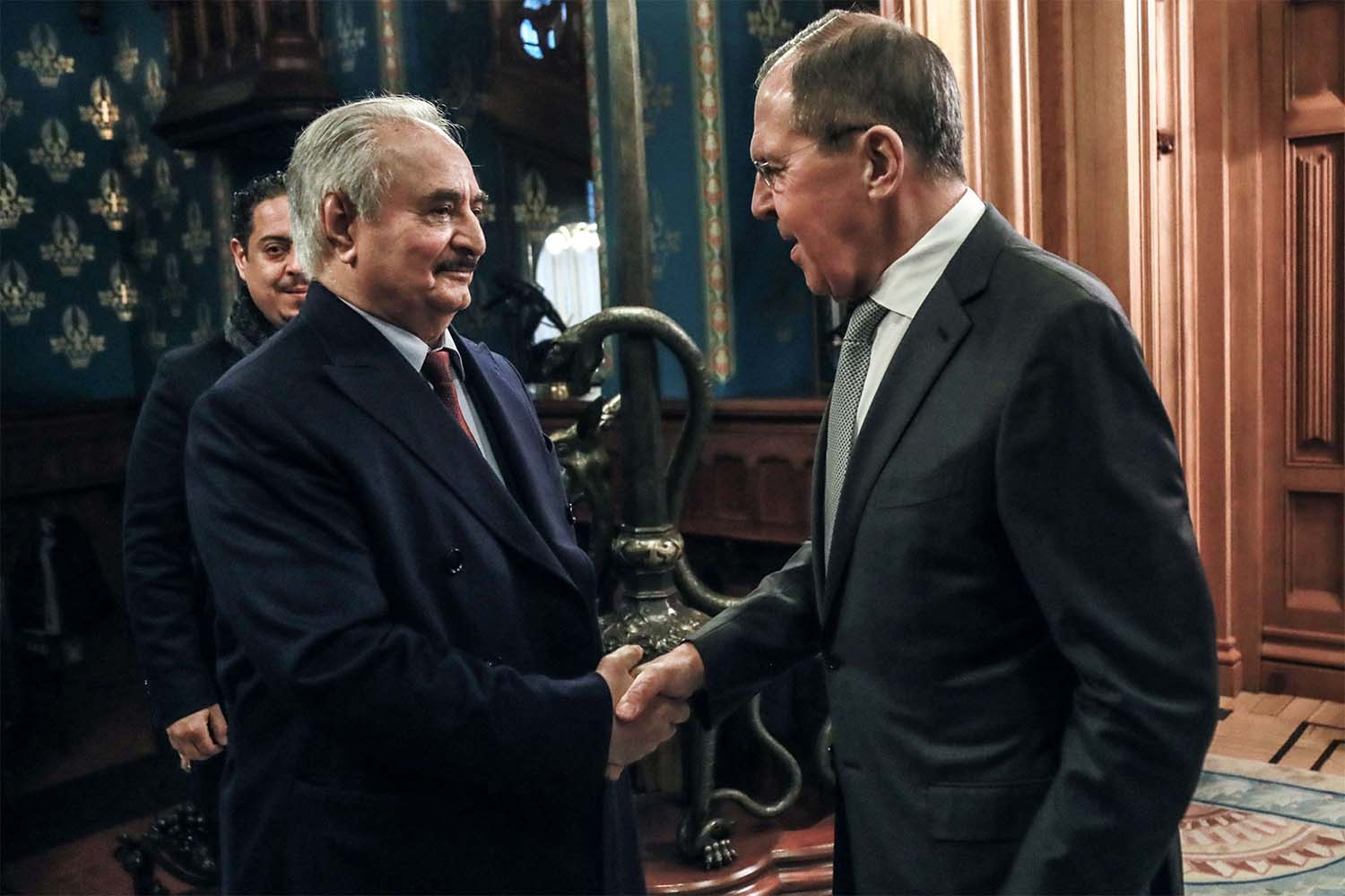 Russian FM Sergei Lavrov (R) shaking hands with Khalifa Haftar