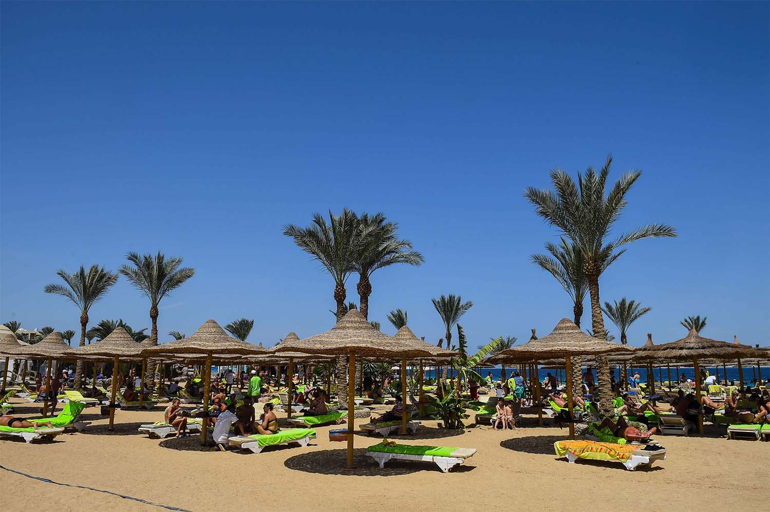 Tourists sunbathe on a beach in Egypt's Red Sea resort town of Hurghada on APril 2019