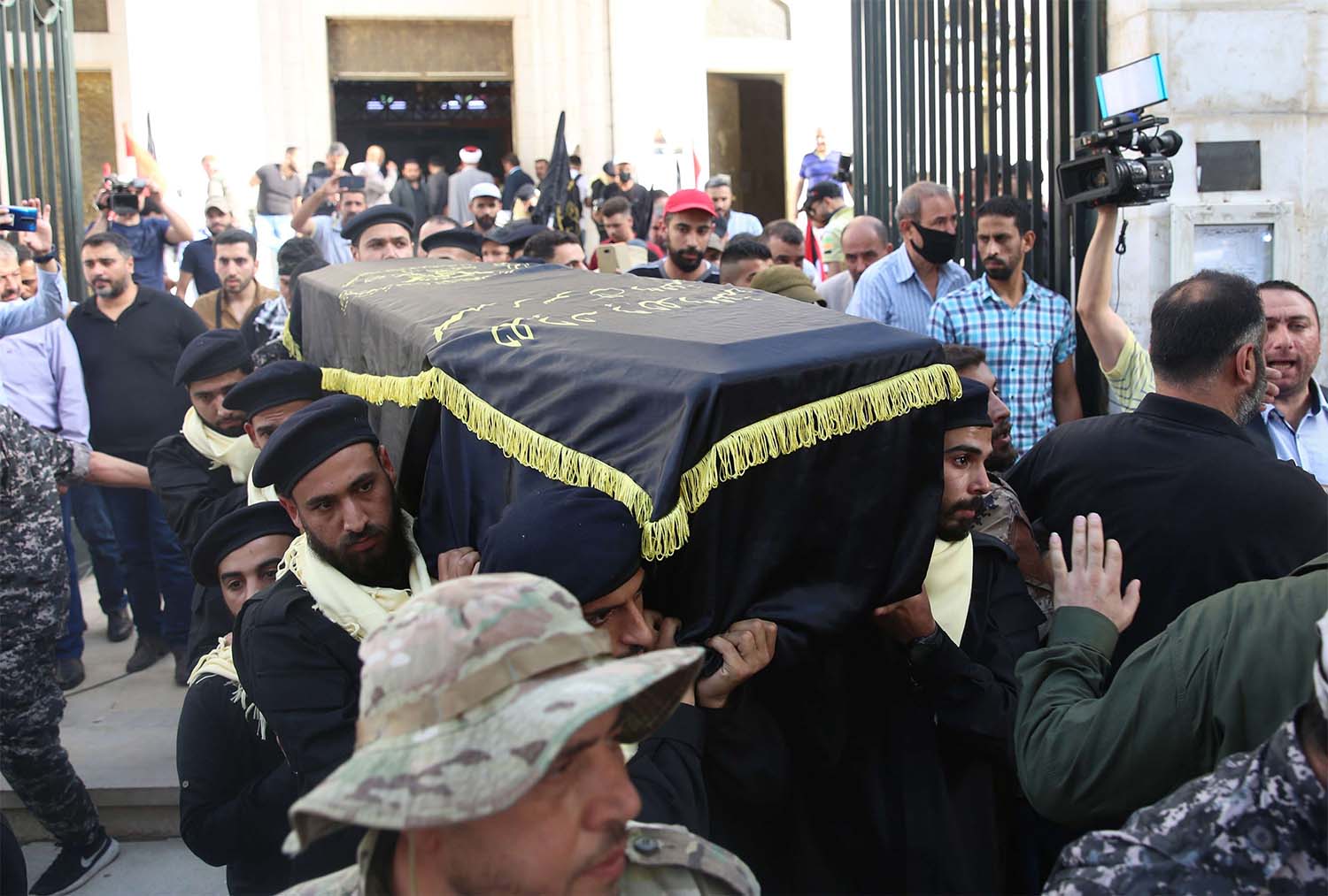 Mourners carry the coffin of Ramadan Shalah, former leader of the Islamic Jihad Movement in Palestine, during his funeral in the Syrian capital Damascus 