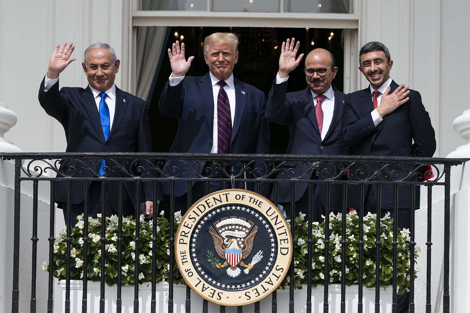Israeli Prime Minister Benjamin Netanyahu, left, President Donald Trump, Bahrain Foreign Minister Khalid bin Ahmed Al Khalifa and United Arab Emirates Foreign Minister Abdullah bin Zayed al-Nahyan react on the Blue Room Balcony after signing the Abraham Accords 