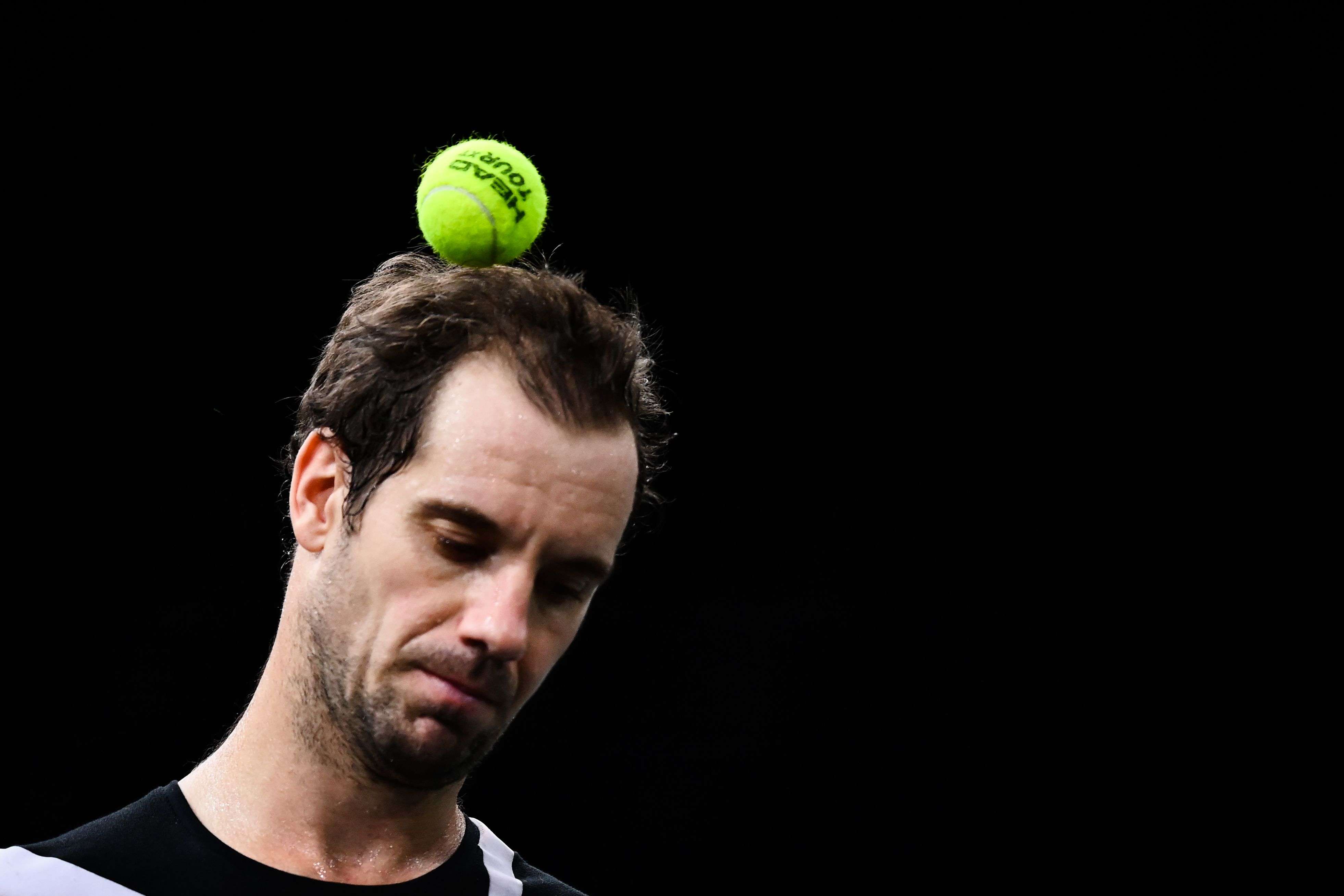 لاعب تنس فرنسي يضع الكرة على رأسه