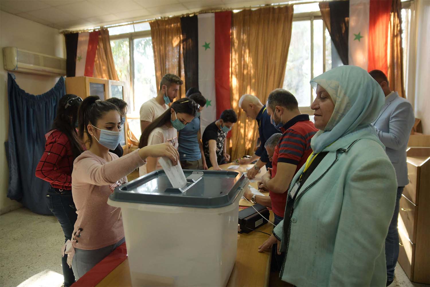 Syrians residing in Lebanon cast their vote during voting for the upcoming presidential election 