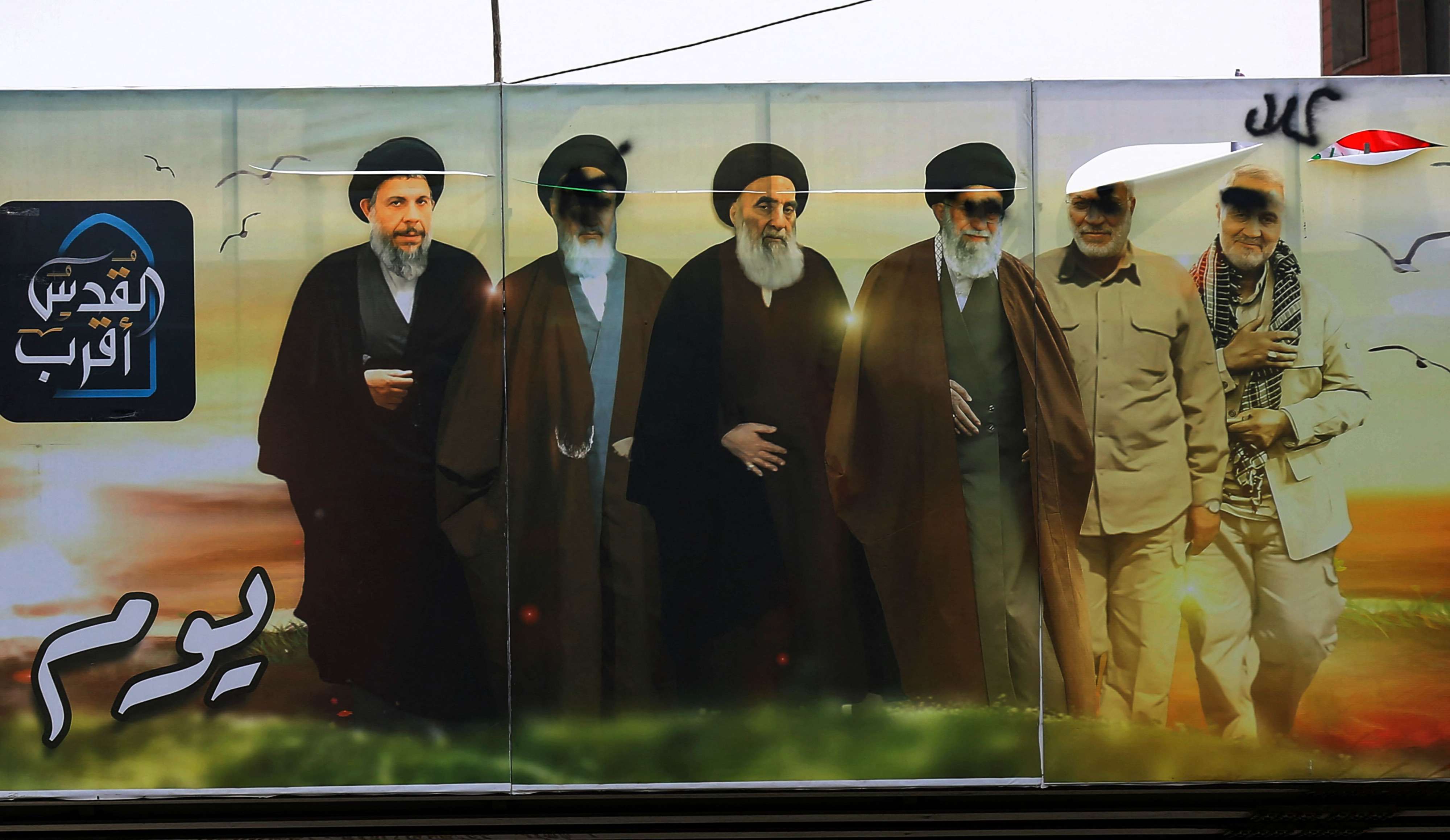 تشويه لصور قادة شيعة عراقيين وإيرانيين وسط بغداد