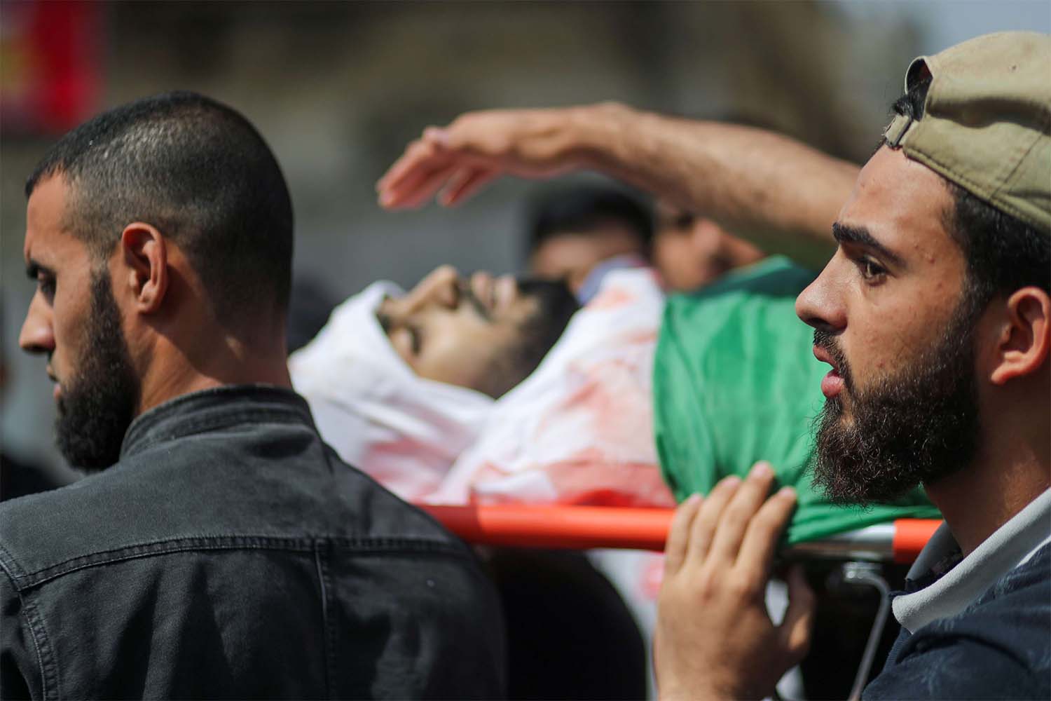 Mourners carry the body of Palestinian man killed by Israeli airstrikes