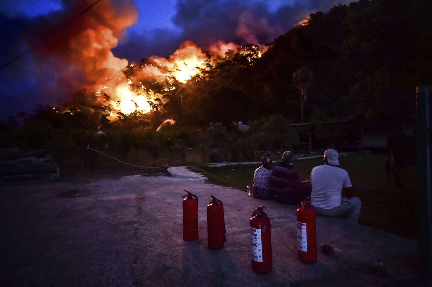 The fires forced thousands of residents and tourists to flee homes or vacation resorts 