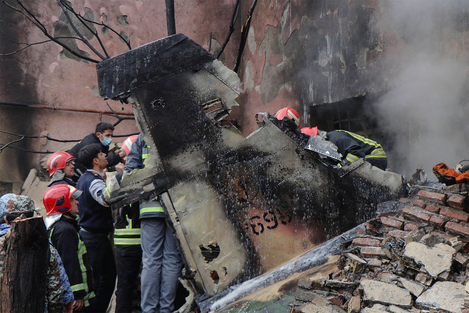 Debris from the crashed fighter jet is seen in Tabriz