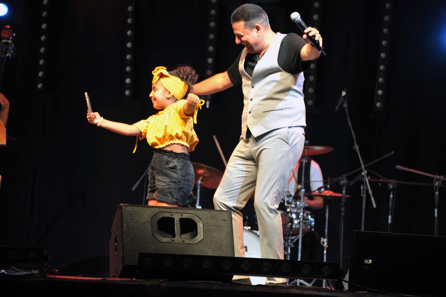 Kabbadj dancing with one of his fans on the stage