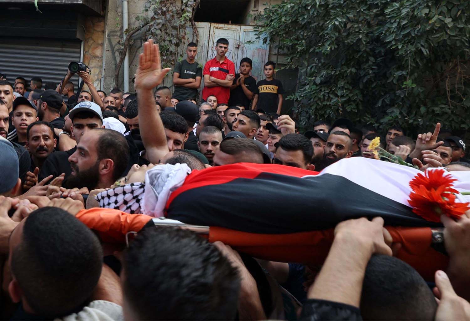 Mourners carry the body of Usayed Hmaidat, a Palestinian youth killed during during a reported Israeli raid on the refugee camp of al-Jalazon near Ramallah 