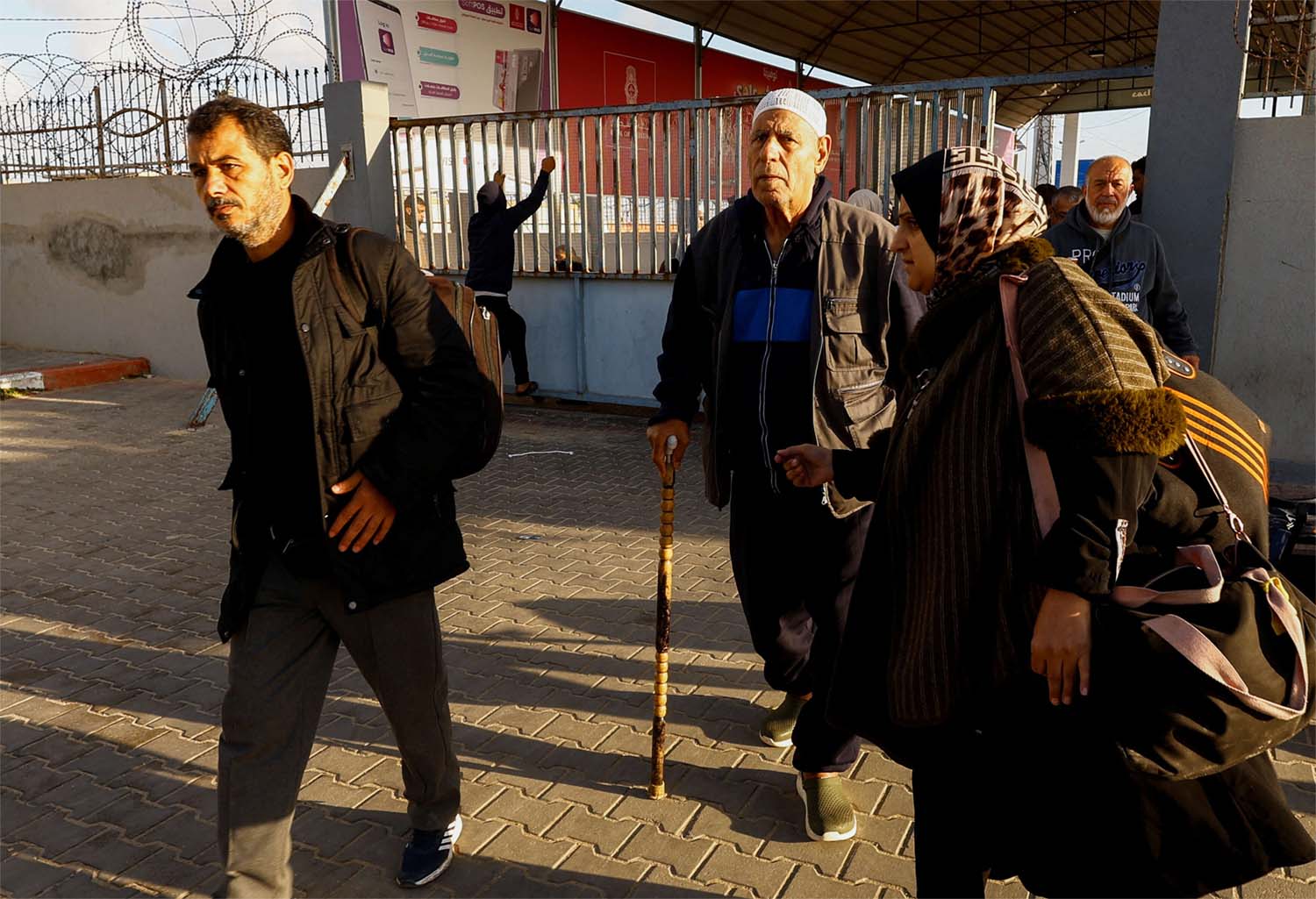 Palestinians with foreign passports arrive at the Rafah border crossing with Egypt