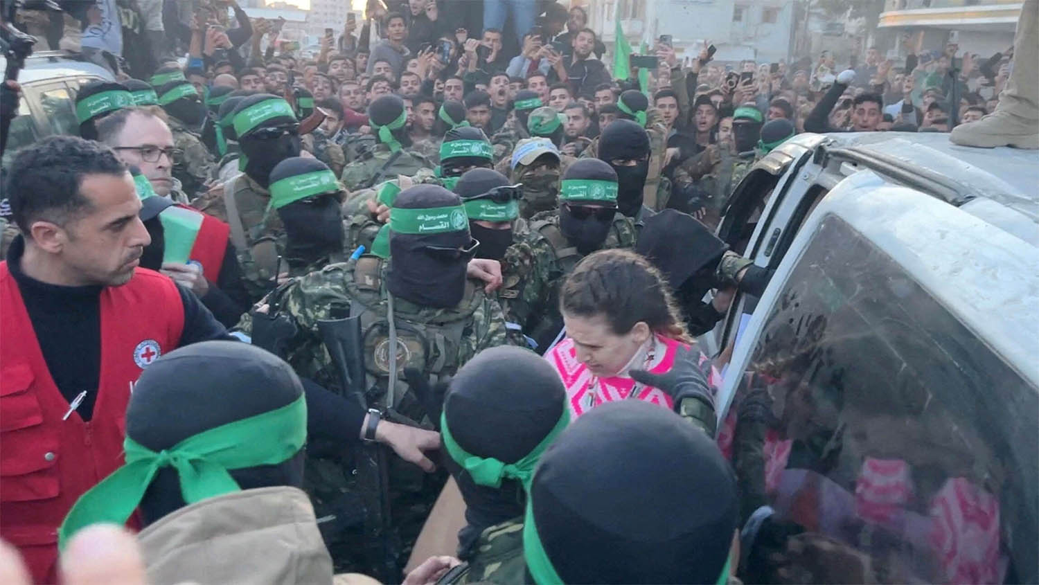 Palestinian Hamas militants hand over Doron Steinbrecher, a hostage who had been held in Gaza 