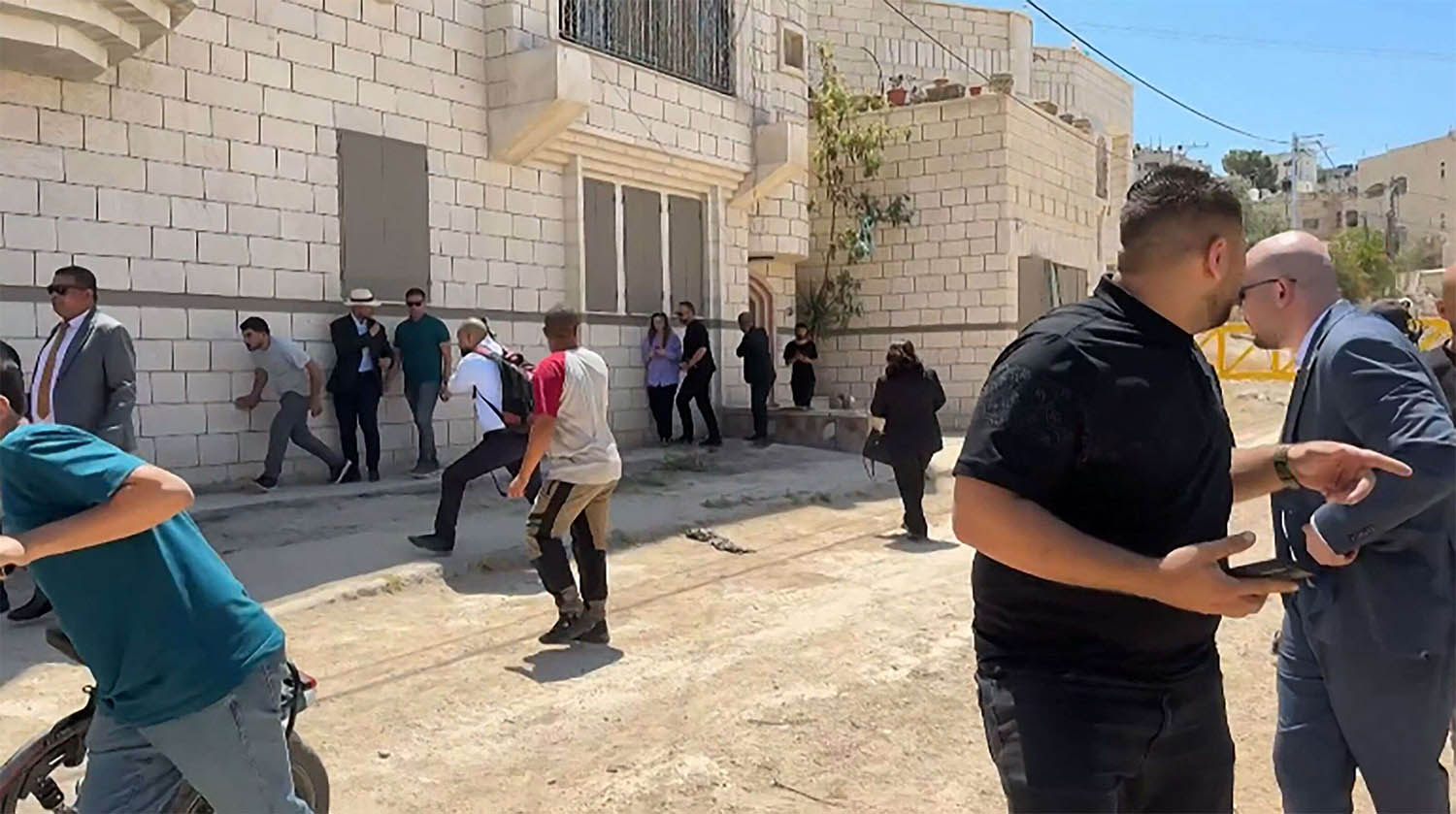 Members of a diplomatic delegation from the European Union reacting after shots were fired as they gathered in Jenin camp