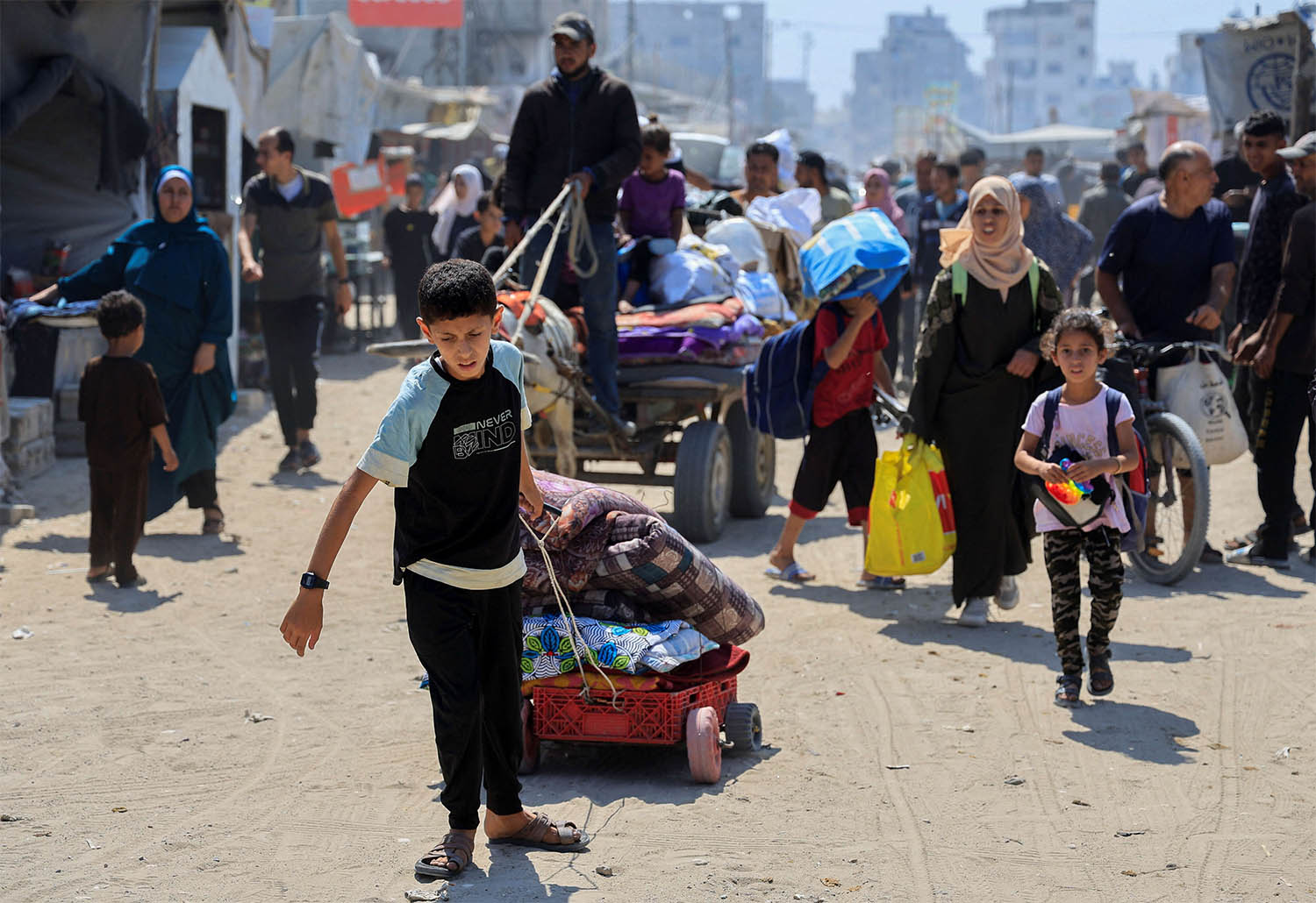 Palestinians fleeing with their belongings after the Israeli army issued evacuation orders, in Khan Younis