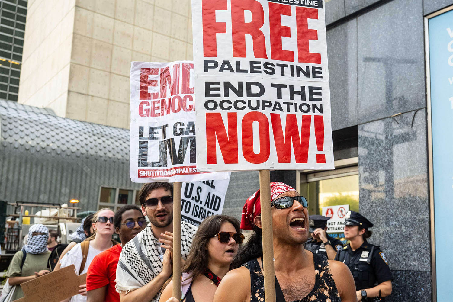 People participate in a protest in support of Palestine outside the UN as a conference on Palestine and a two-state solution takes place inside the UN 