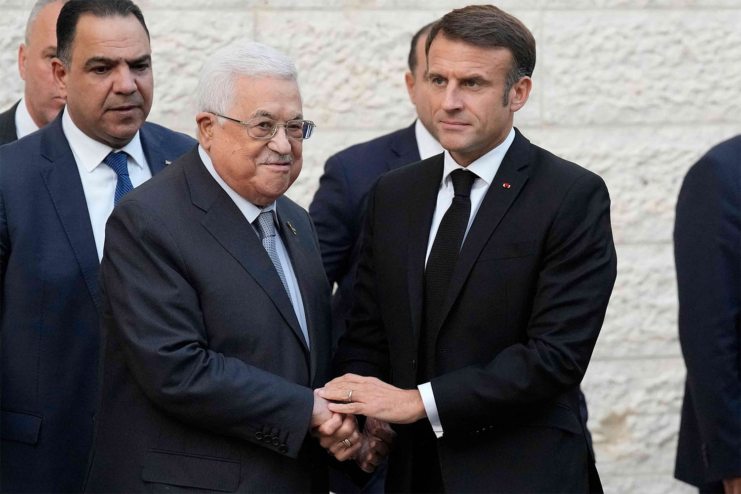 Macron shaking hands with Abbas