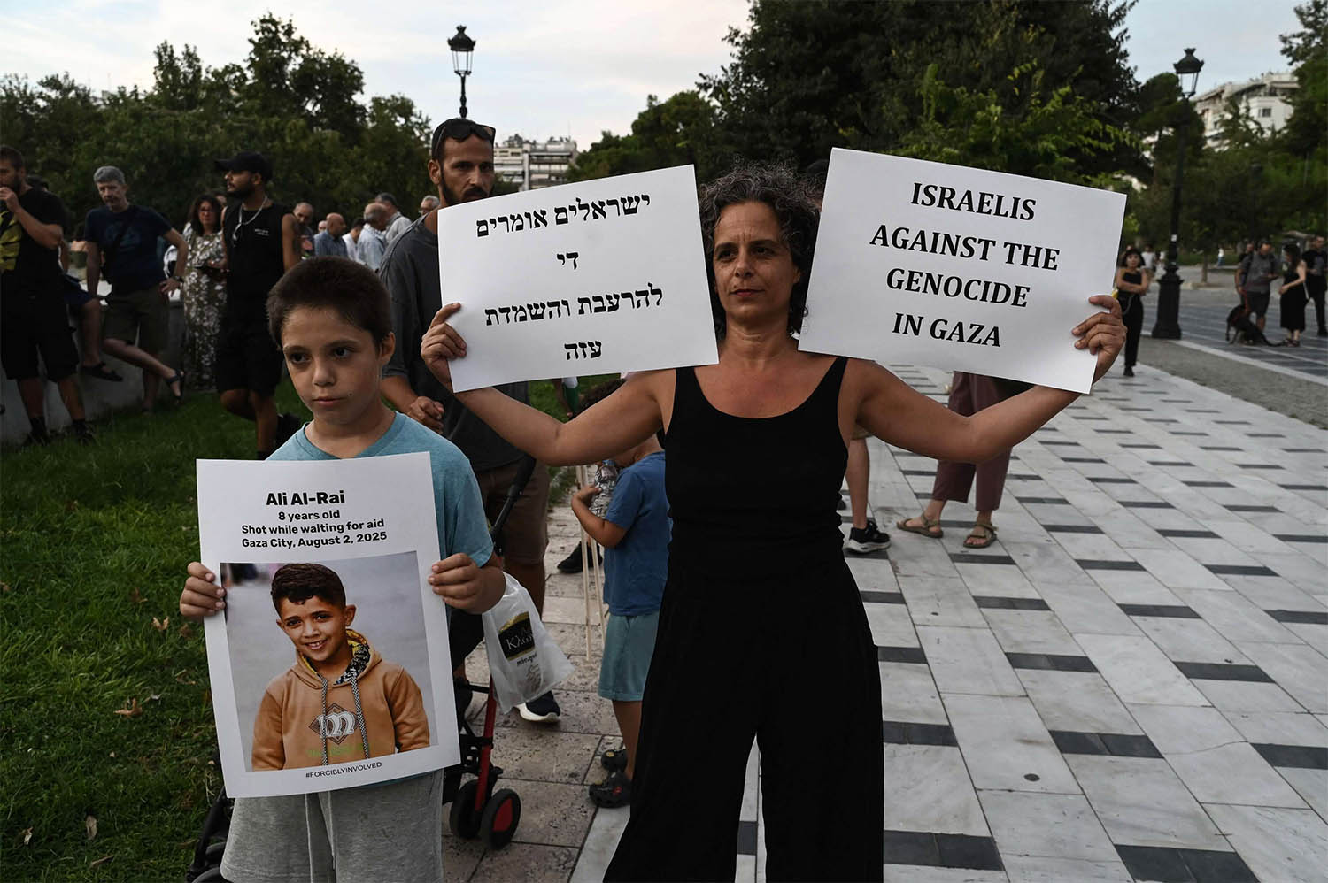 An Israeli citizen holds placard as she take part in a pro-Palestinian rally against Israels actions and ongoing food shortages in the Gaza Strip, during a protest in Thessaloniki 