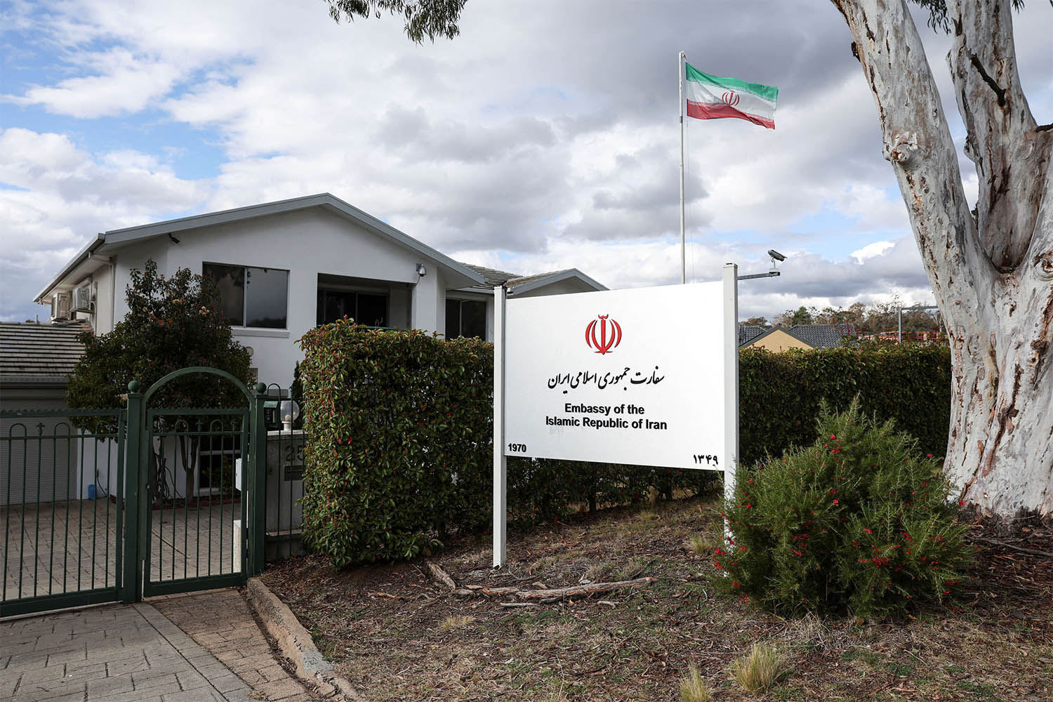 An Iranian flag flutters outside the Iran Embassy in Australia