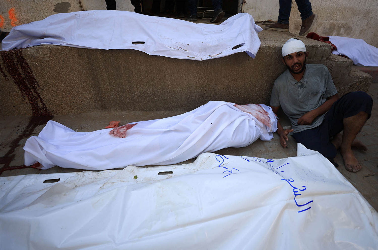 A mourner reacts during the funeral of Palestinians killed in overnight Israeli strikes at Al-Shifa Hospital in Gaza City