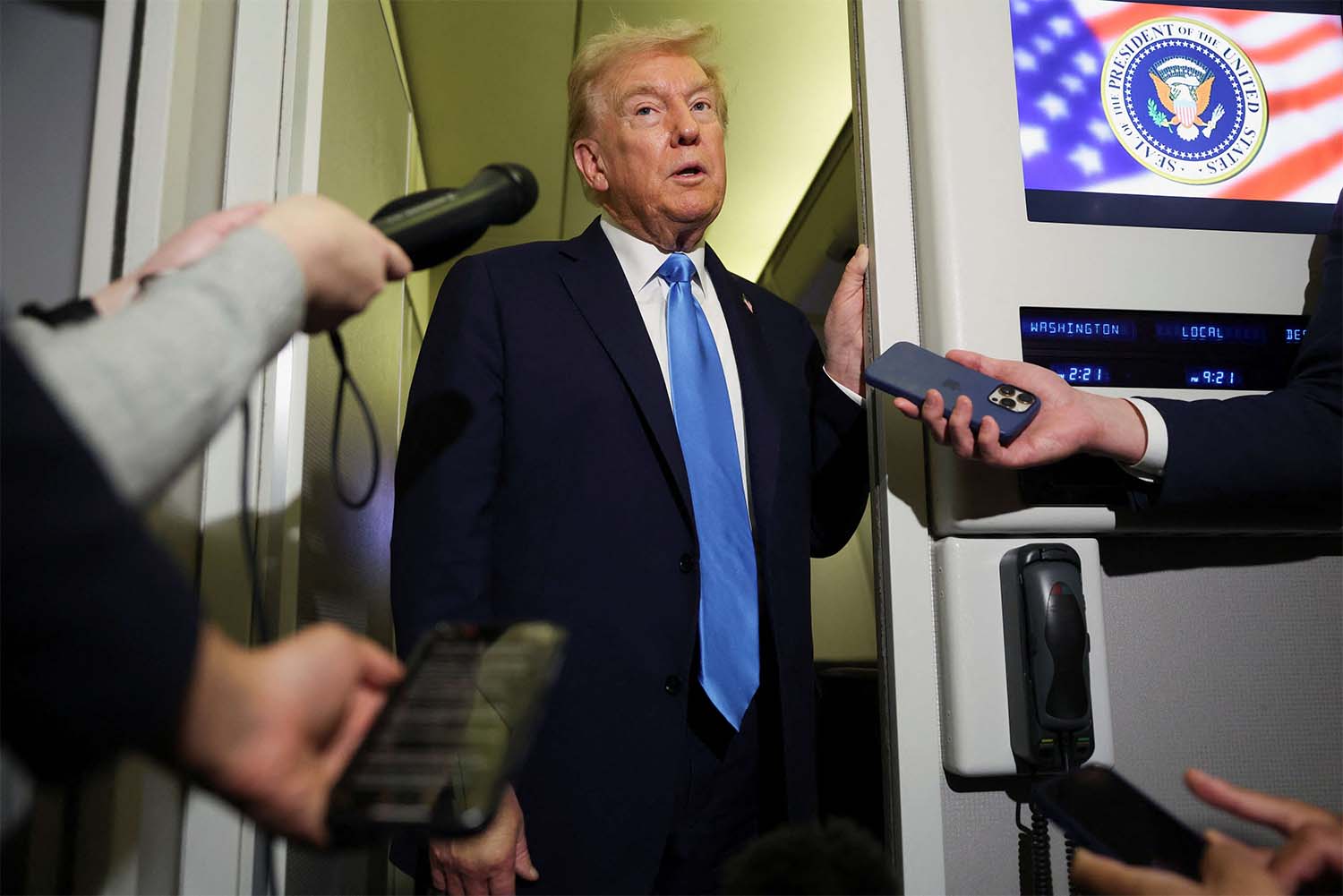 Trump speaks to the media aboard Air Force One 