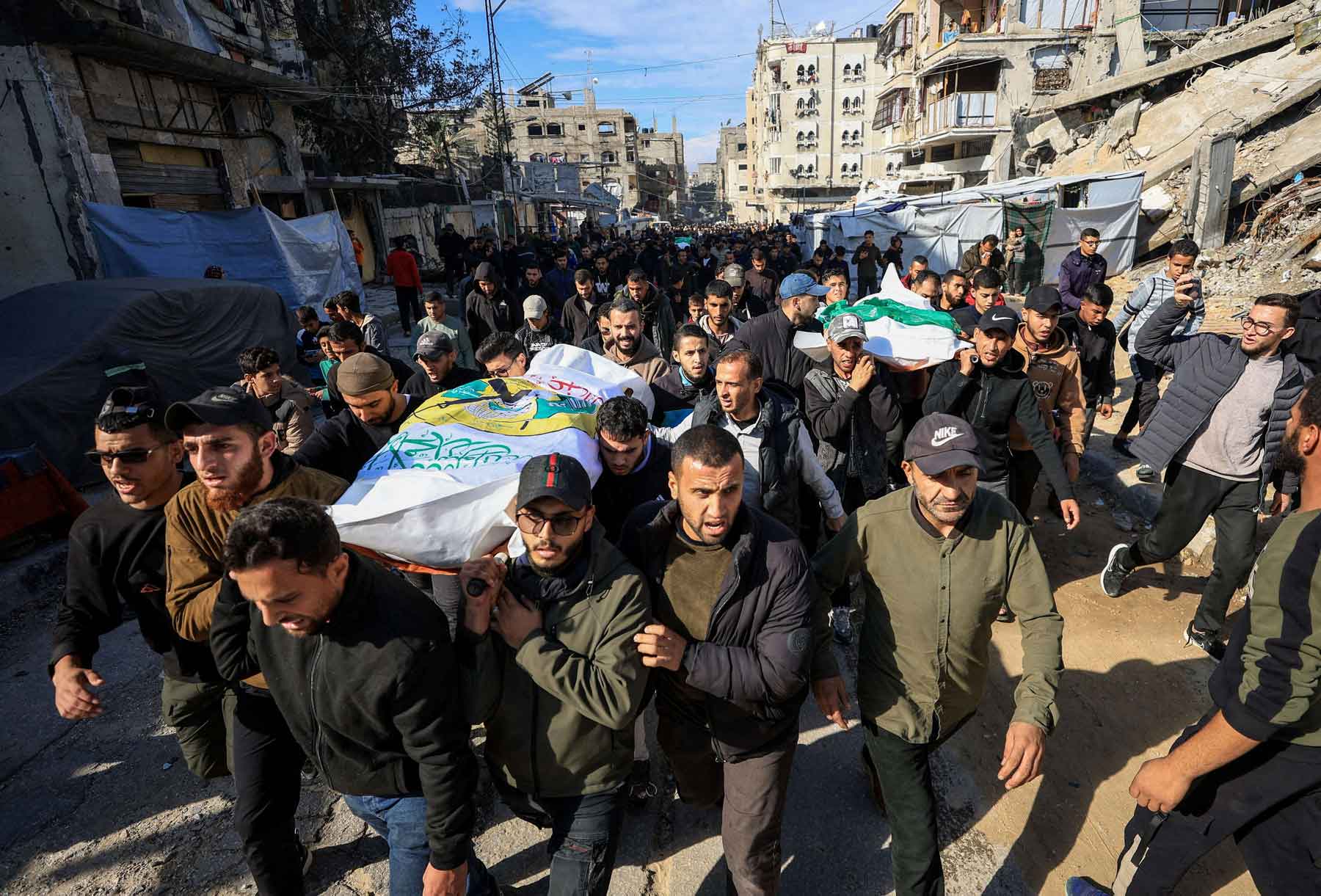 Mourners carry bodies during the funeral of Hamas senior commander Raed Saed and his aides, in Gaza City, December 14, 2025. 