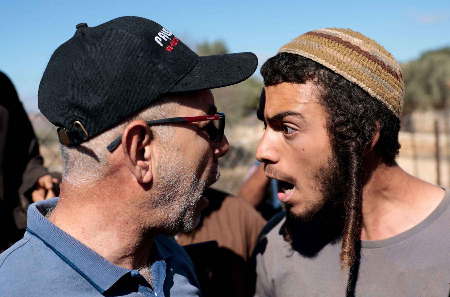 An Israeli settler argues with a Palestinian farmer, during olive harvesting in Silwad, in the Israeli-occupied West Bank, October 29, 2025. 