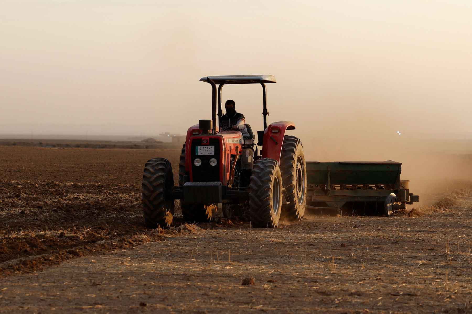 A farmer drives a tractor to plow land for wheat cultivation on the outskirts of Mosul, Iraq, November 26, 2025. 