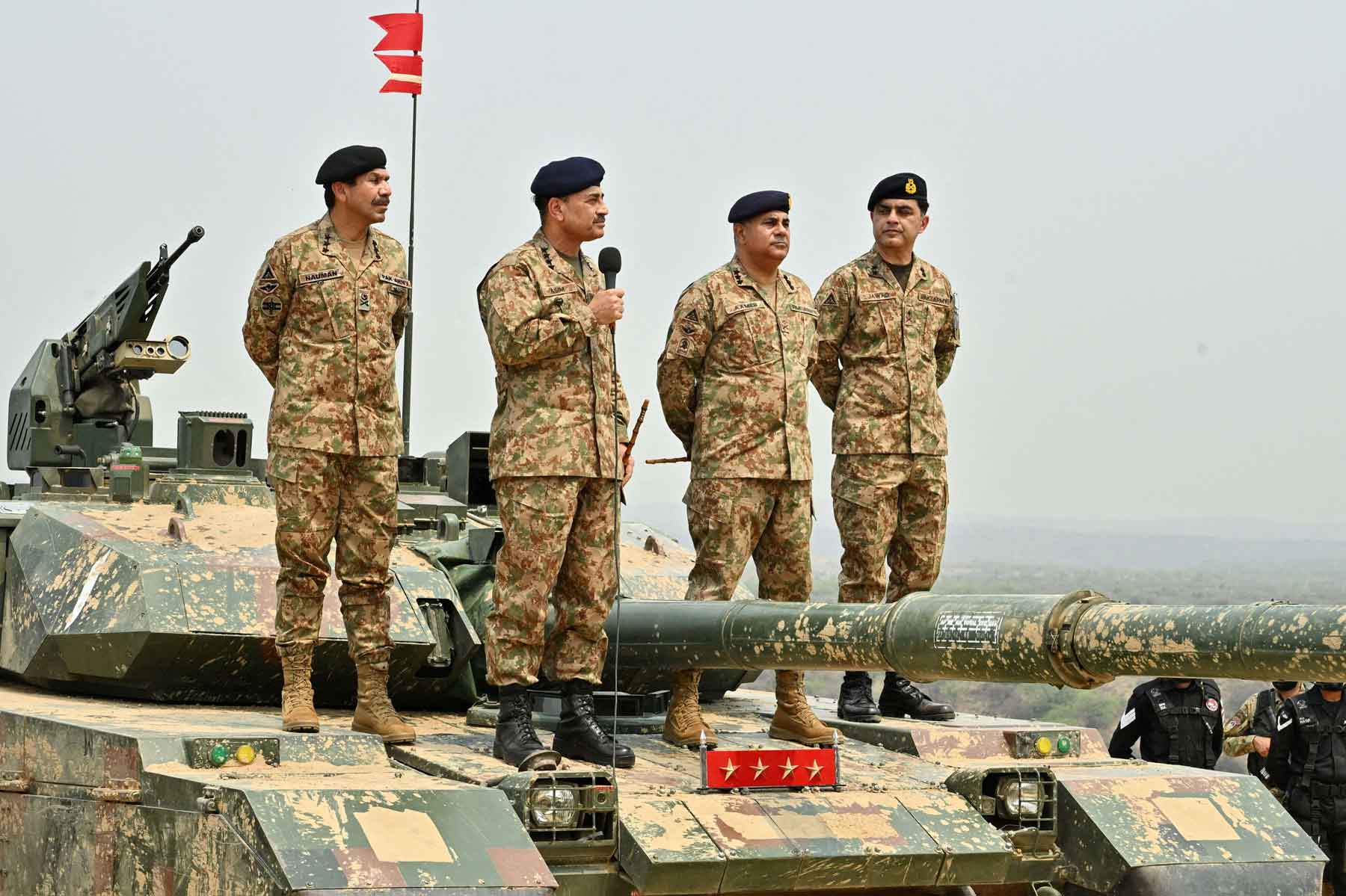 Chief of Army Staff of Pakistan Asim Munir holds a microphone during his visit at the Tilla Field Firing Ranges (TFFR), in Mangla, Pakistan, May 1, 2025. 