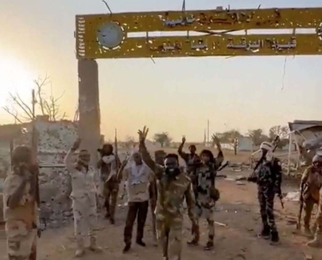 Members of Sudans paramilitary Rapid Support Forces (RSF) stand in front of the main gate of the 22nd SAF Infantry Division, in Babanusa