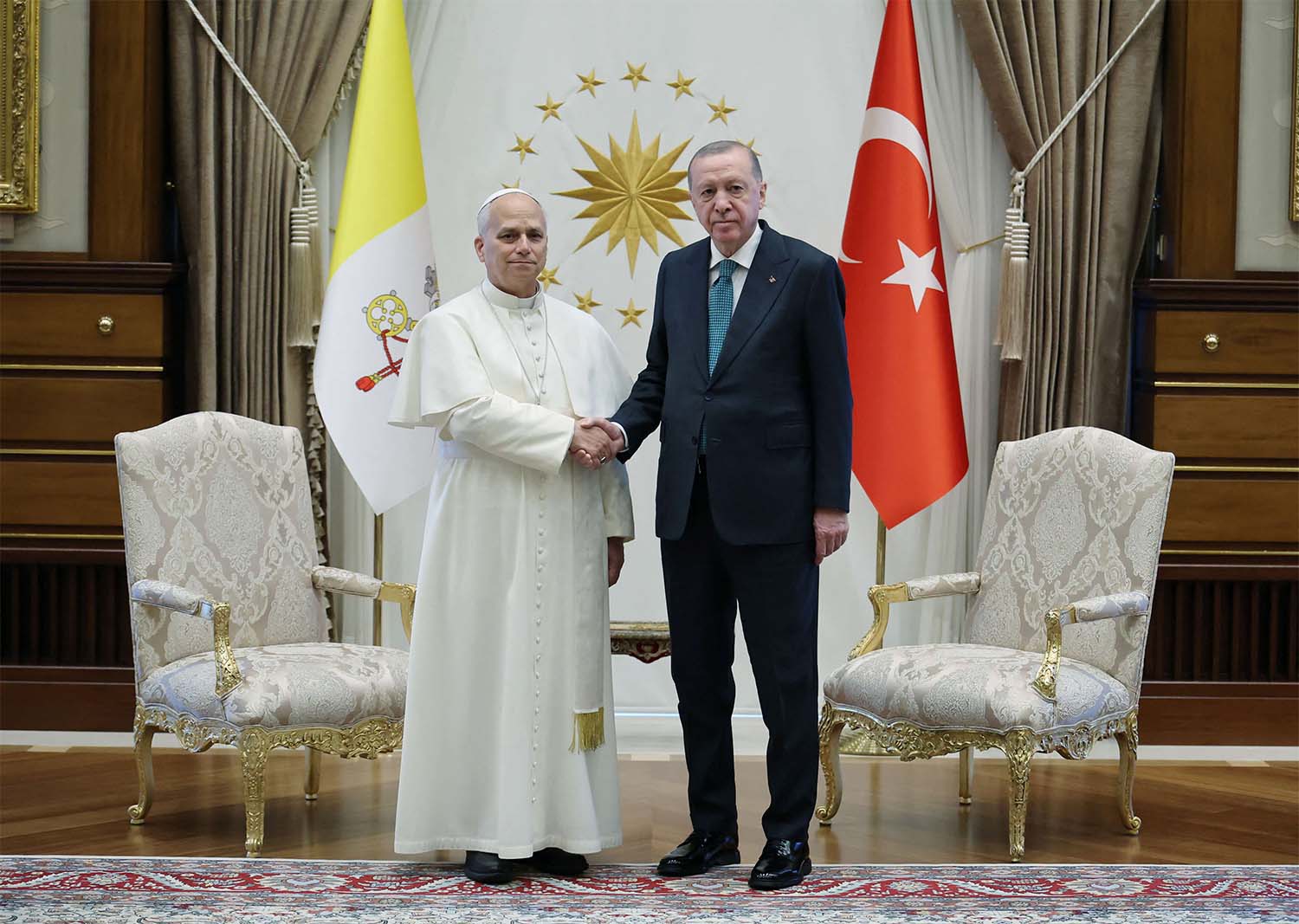 Pope Leo XIV shakes hands with Turkish President Tayyip Erdogan as they meet at the Presidential Palace in Ankara
