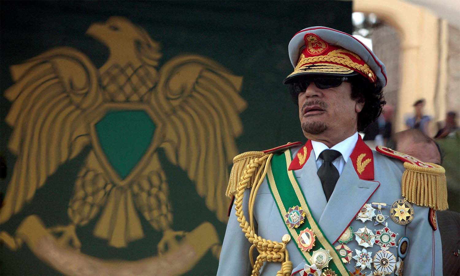 Late leader Muammar Gaddafi attends a celebration of the 40th anniversary of his coming to power at the Green Square in Tripoli September 1, 2009