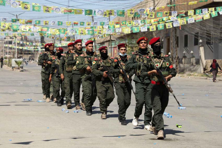 Armed members of the Syrian Democratic Forces (SDF) military police take part in a demonstration under the banner “With our will, we will protect our revolution,” in Qamishli, Syria, September 17, 2025. 