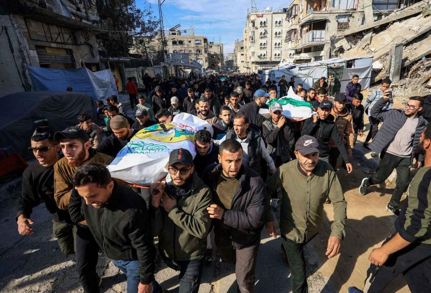 Mourners carry bodies during the funeral of Hamas senior commander Raed Saed and his aides, in Gaza City, December 14, 2025. 