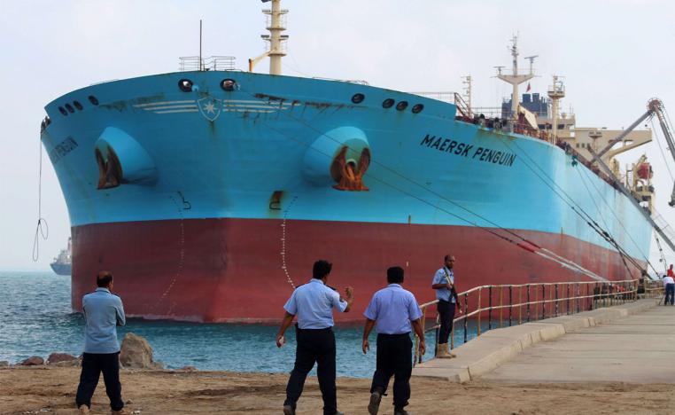 Security guards stand by a ship docked in the southern Yemeni port of Aden