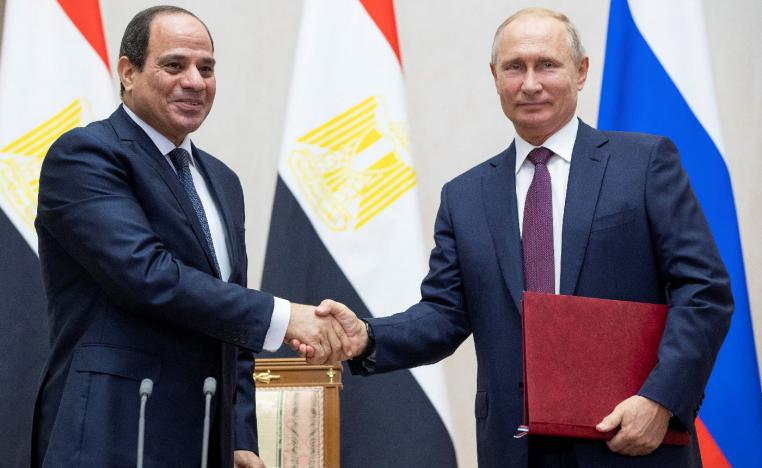 Russian President Vladimir Putin and Egyptian President Abdel Fattah al-Sisi shake hands.