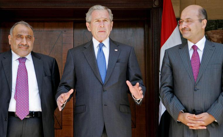 الرئيس الأميركي الأسبق جورج بوش بين برهم صالح وعادل عبد المهدي