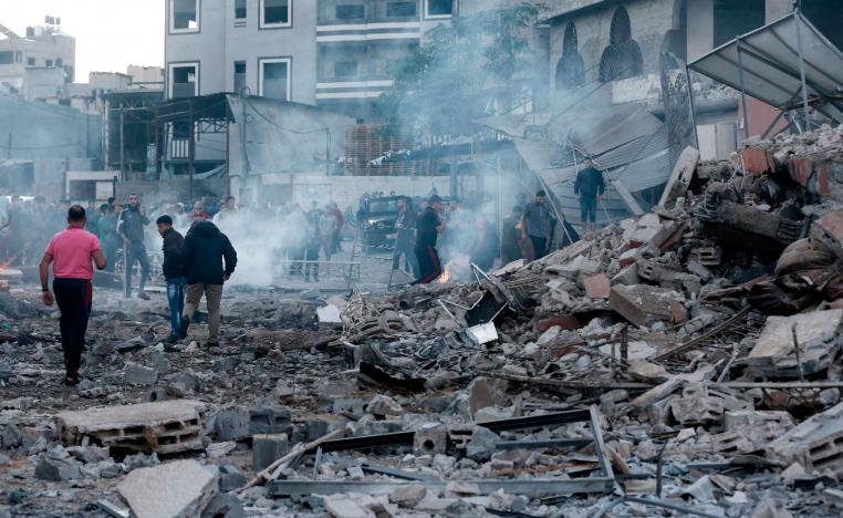 People inspect the rubble of a building following an Israeli air strike on Gaza City on October 27, 2018.
