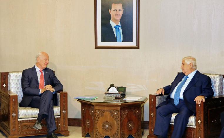 Syria's Foreign Minister Walid al-Muallem, right, meets with UN Special Envoy for Syria Staffan de Mistura.