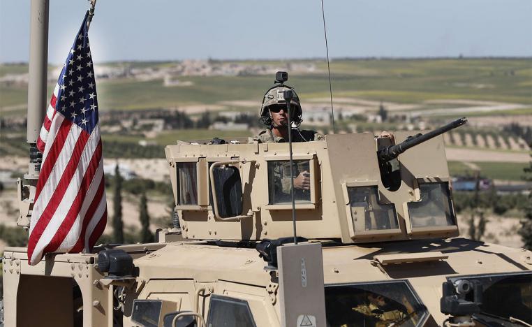 US soldier sits in an armored vehicle