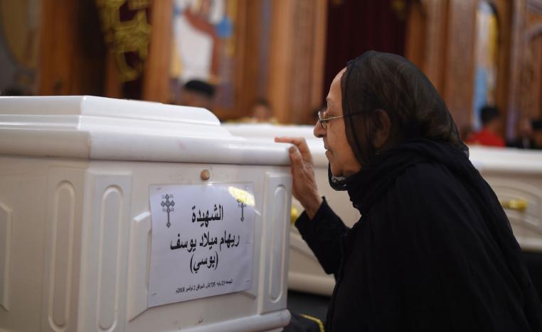 A relative of a slain Christian grieves during funeral service in Minya, Egypt.