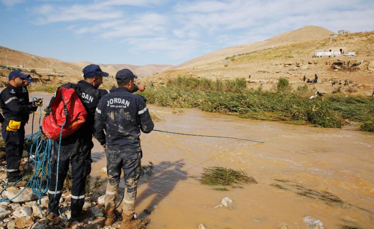 Civil defense members look for missing persons after rain storms unleashed flash floods, in Madaba city, near Amman, Jordan, November 10, 2018.