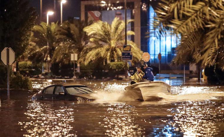 People are using a boat on the flooded main road of the Daeya area of Kuwait city 