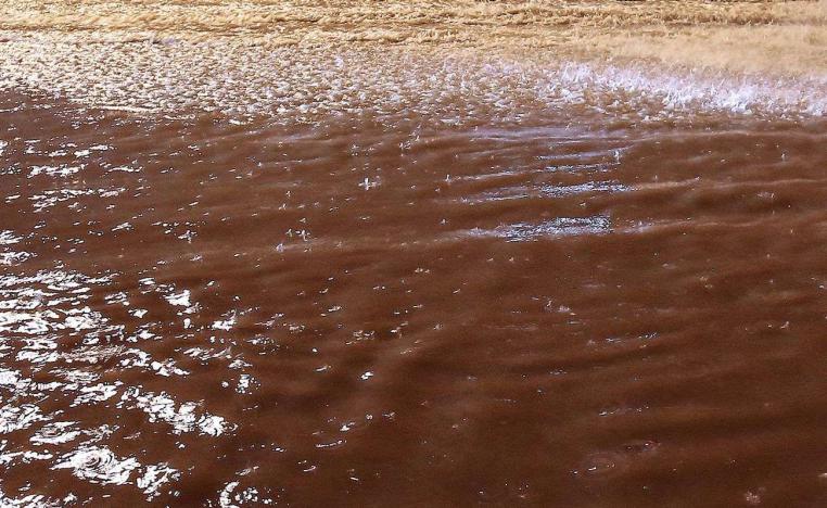 Floods have uncovered and carried away scores of mines, bombs and ammunition left by the Iraqi army in desert areas