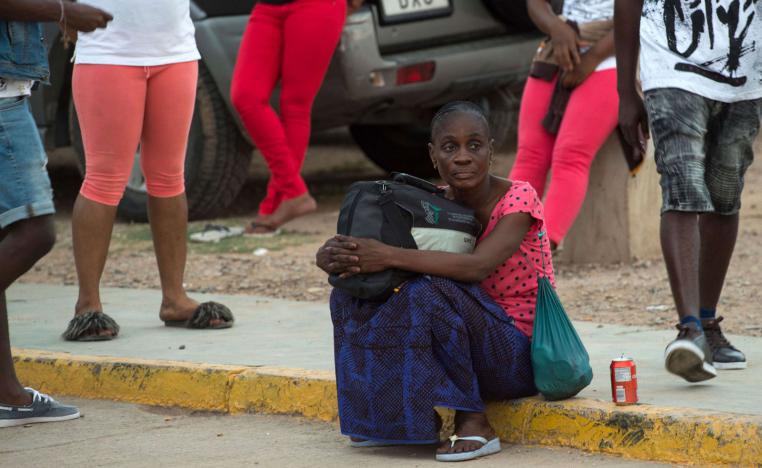 A Sub-Saharan migrant sits as she waits to leave the temporary centre for immigrants and asylum seekers in the Spanish enclave of Melilla on September 19 , 2018.