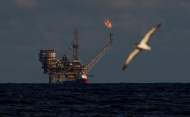 A seagull flies in front of an oil platform in the Bouri Oilfield some 70 nautical miles north of the coast of Libya, October 5, 2017.