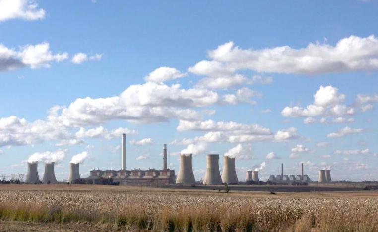 Open to debate. Smoke rises from the cooling towers of the Matla Power Station, a coal-fired power plant in South Africa.