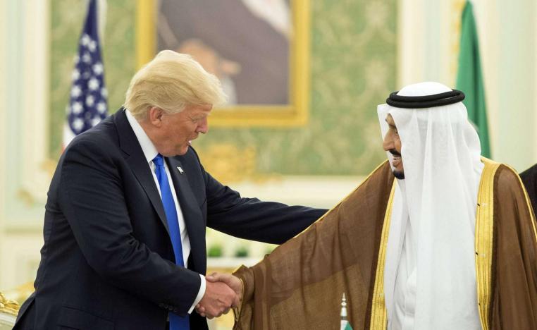Saudi King Salman shakes hands with US President Donald Trump