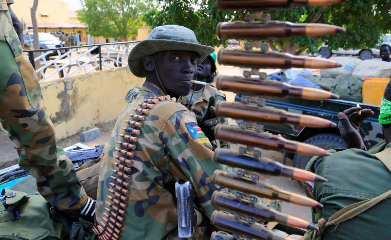 A South Sudanese soldier stands next to a machine gun mounted on a truck in Malakal town, northeast of Juba, South Sudan December 30, 2013. 