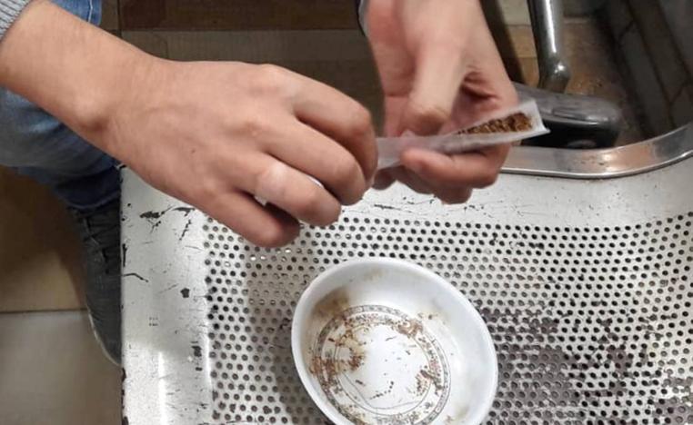 A youth rolls a cigarette with a new kind of drug called "Strox", in Cairo Egypt October 14, 2018.