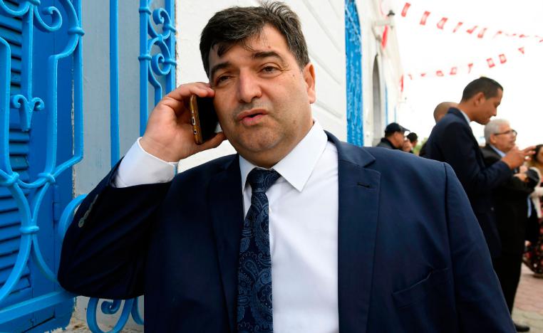 Rene Trabelsi speaking on the phone outside the Ghriba Synagogue in Djerba.
