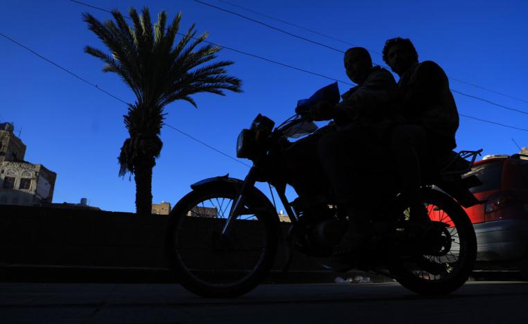 Yemenis ride a motorbike past historical buildings in the old quarter of the capital Sanaa on November 14, 2018.